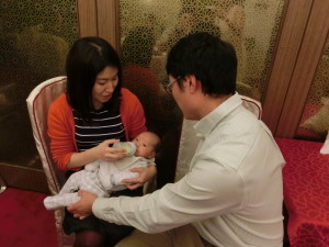 Yuka is taking her first lesson in bottle feeding